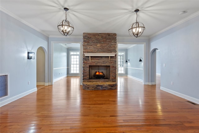 unfurnished living room featuring ornamental molding, hardwood / wood-style flooring, and a fireplace