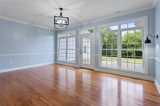 interior space featuring plenty of natural light, light hardwood / wood-style floors, and crown molding