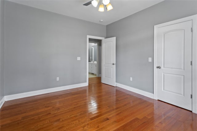 unfurnished bedroom with ceiling fan and hardwood / wood-style flooring