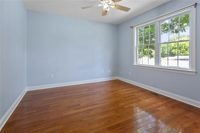 spare room featuring ceiling fan and dark hardwood / wood-style floors