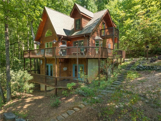 rear view of property featuring french doors and a deck