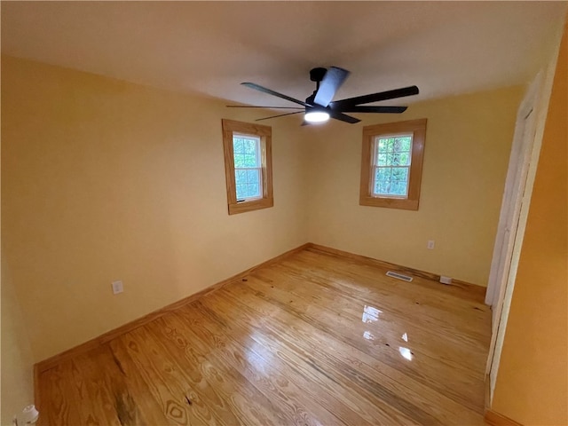 spare room featuring light hardwood / wood-style floors and ceiling fan