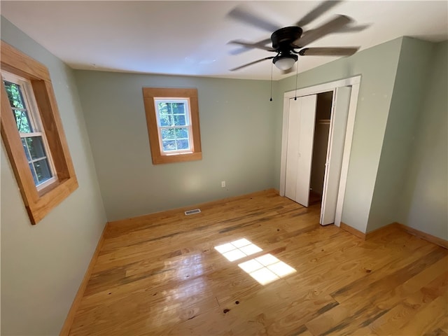 unfurnished bedroom featuring light wood-type flooring and ceiling fan