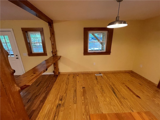 unfurnished dining area featuring hardwood / wood-style floors and a healthy amount of sunlight