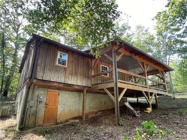 back of house with a deck