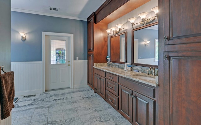 bathroom with crown molding and vanity