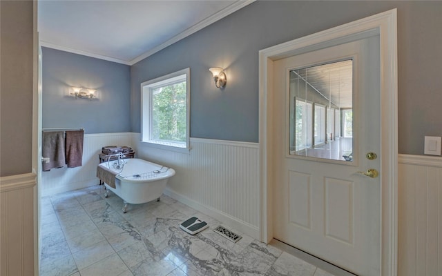 bathroom featuring ornamental molding, lofted ceiling, and a bathtub