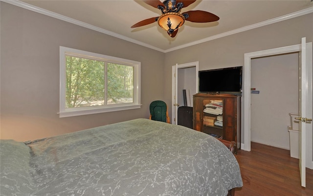 bedroom featuring ceiling fan, ornamental molding, and wood-type flooring