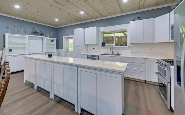 kitchen with a center island, sink, stainless steel appliances, and white cabinets