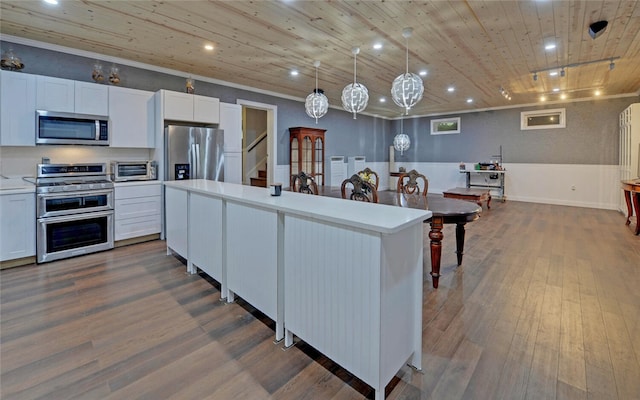 kitchen featuring wood ceiling, white cabinetry, stainless steel appliances, wood-type flooring, and a center island