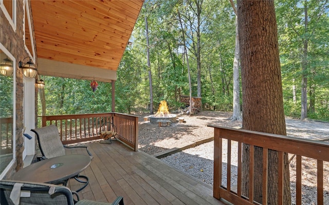 wooden deck with an outdoor fire pit