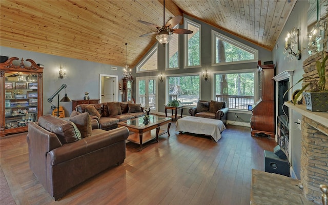 living room featuring wood-type flooring, a fireplace, and high vaulted ceiling