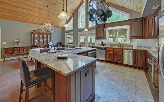 kitchen with wood ceiling, a kitchen island, decorative light fixtures, a notable chandelier, and light stone countertops