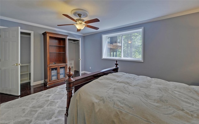 bedroom with ornamental molding, dark hardwood / wood-style flooring, and ceiling fan