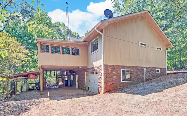 view of side of home featuring a garage and a carport