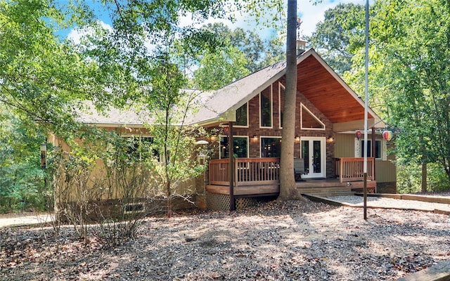 rear view of house with a deck and french doors