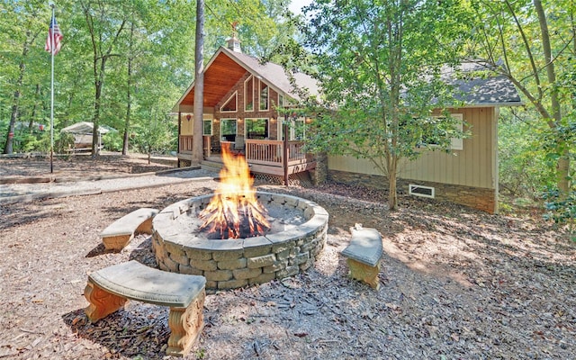 view of patio with a deck and a fire pit