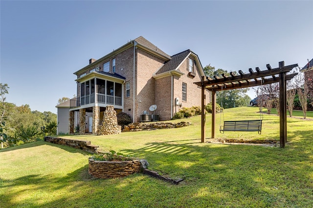 exterior space with a pergola, a sunroom, and a yard