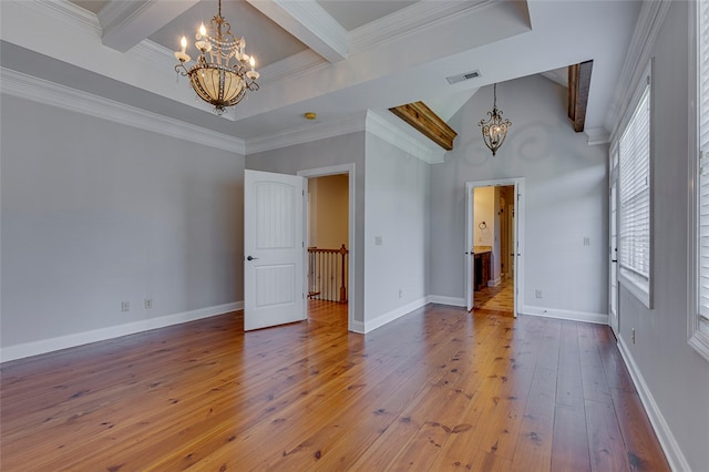 unfurnished room featuring wood-type flooring, ornamental molding, an inviting chandelier, and beamed ceiling