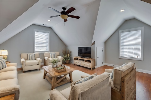 living room featuring light hardwood / wood-style flooring, lofted ceiling, and ceiling fan