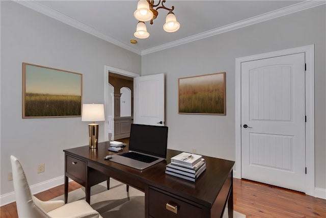 office area with ornamental molding, a notable chandelier, and hardwood / wood-style flooring