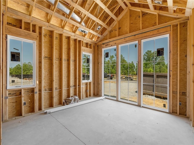 misc room featuring lofted ceiling and concrete floors