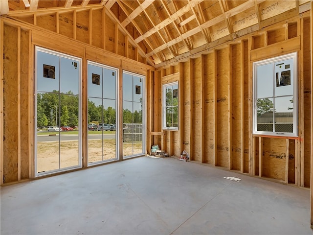 miscellaneous room featuring lofted ceiling and concrete flooring