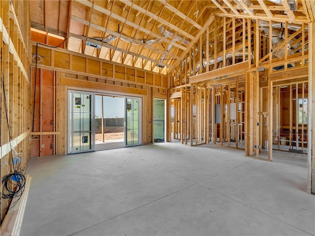 miscellaneous room featuring concrete floors and high vaulted ceiling