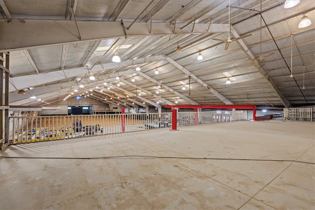 miscellaneous room with lofted ceiling and concrete floors