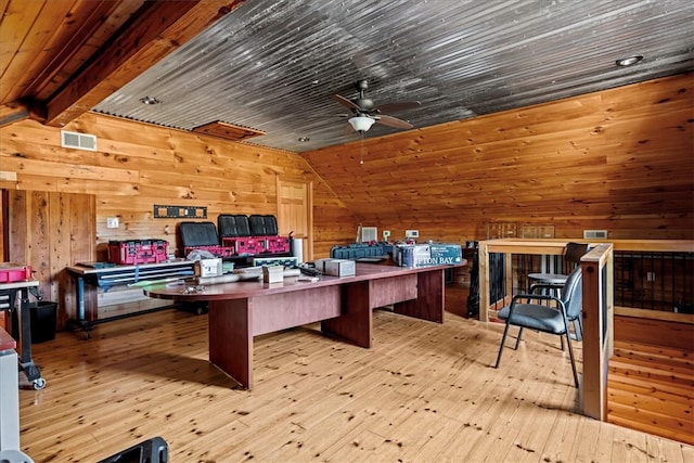 office space featuring light wood-type flooring, wood ceiling, wood walls, and ceiling fan