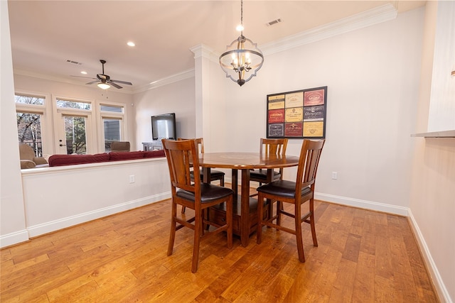 dining space featuring hardwood / wood-style flooring, ceiling fan with notable chandelier, and ornamental molding