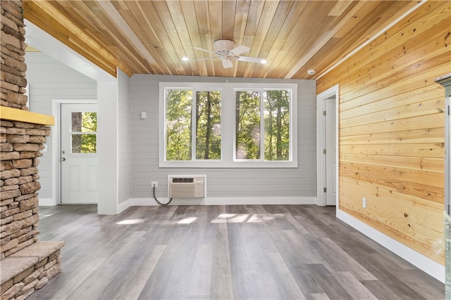 unfurnished living room featuring hardwood / wood-style flooring, a wall mounted AC, wood walls, and wooden ceiling