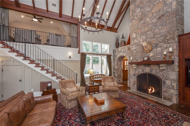 living room featuring wood ceiling, high vaulted ceiling, a fireplace, beam ceiling, and hardwood / wood-style flooring