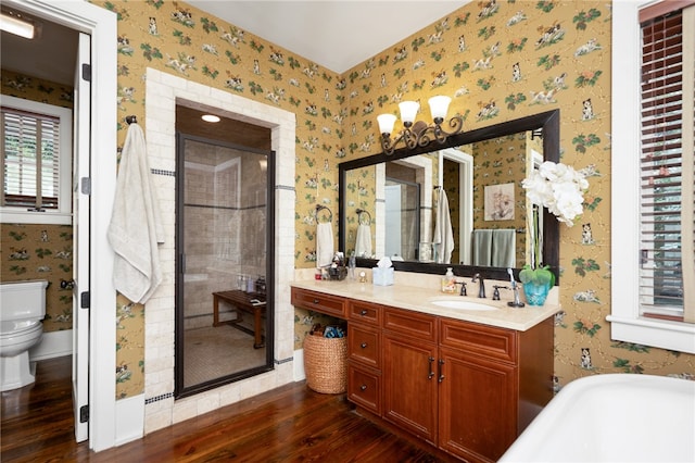 full bathroom featuring plus walk in shower, wood-type flooring, vanity, and toilet