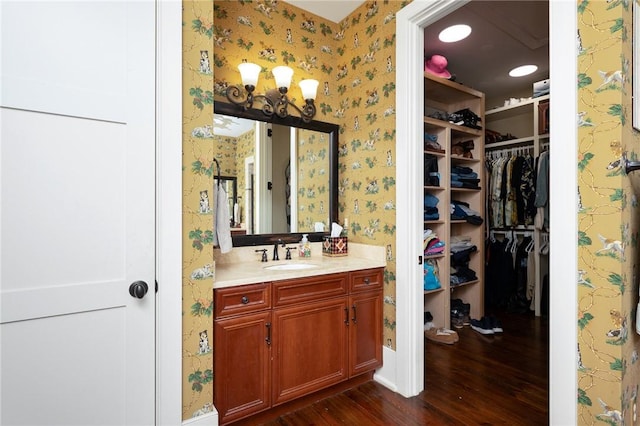 202 Passion Flower Way, Sunset, SC 29685 - bathroom with wallpapered walls, wood finished floors, vanity, and a walk in closet
