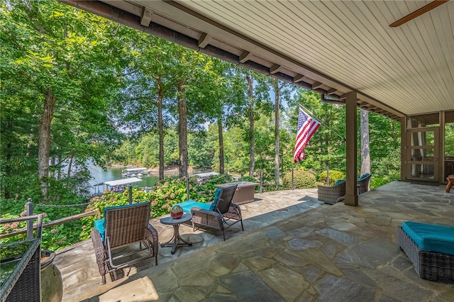 view of patio / terrace with a water view and outdoor lounge area