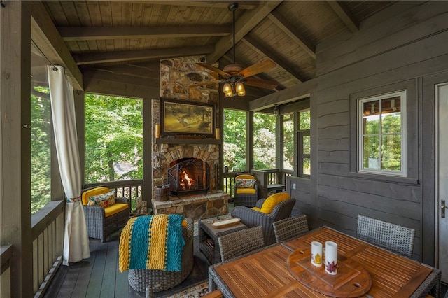 sunroom with wooden ceiling, lofted ceiling with beams, and ceiling fan