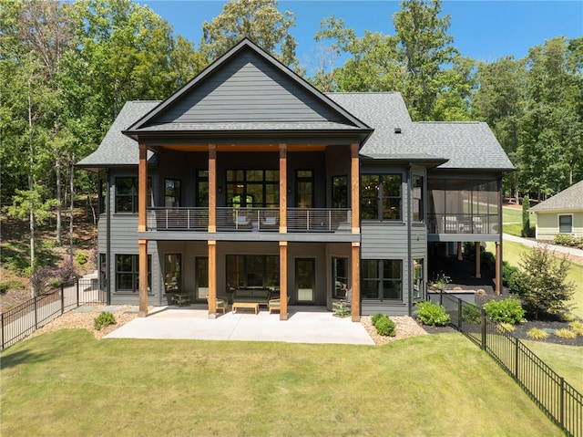 rear view of house featuring an outdoor living space, a yard, a balcony, and a patio area