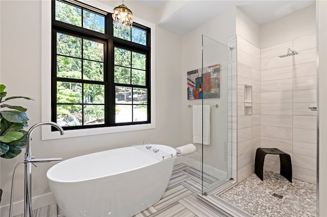 bathroom featuring tile patterned flooring, separate shower and tub, and a wealth of natural light