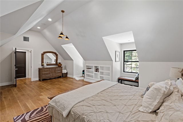 bedroom featuring light hardwood / wood-style flooring and vaulted ceiling with skylight