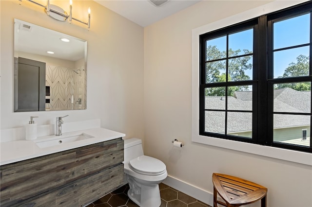 bathroom featuring toilet, vanity, and tile patterned floors