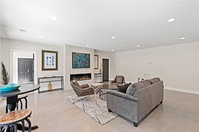 living room featuring a large fireplace