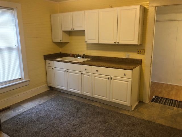 kitchen featuring white cabinets and sink