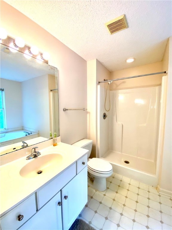 bathroom with vanity, a shower, toilet, and a textured ceiling