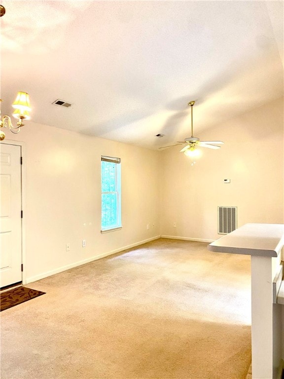 unfurnished living room with carpet flooring, a textured ceiling, and ceiling fan