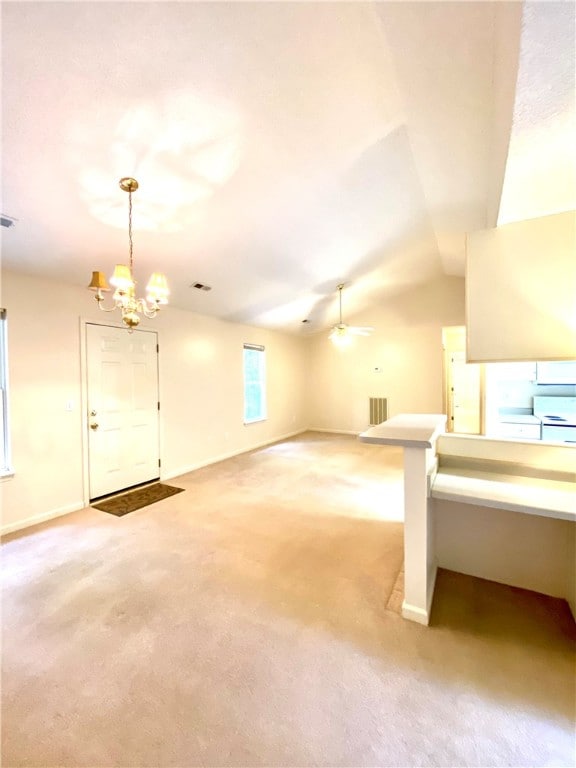 additional living space featuring light carpet, ceiling fan with notable chandelier, and lofted ceiling