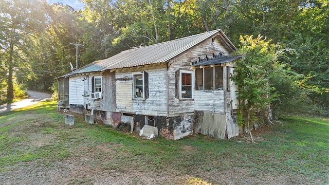 view of property exterior with a lawn