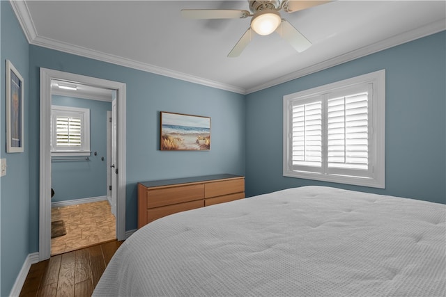 bedroom featuring dark wood-type flooring, ceiling fan, and ornamental molding