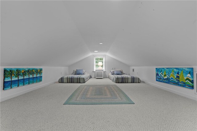 unfurnished bedroom featuring lofted ceiling and light carpet