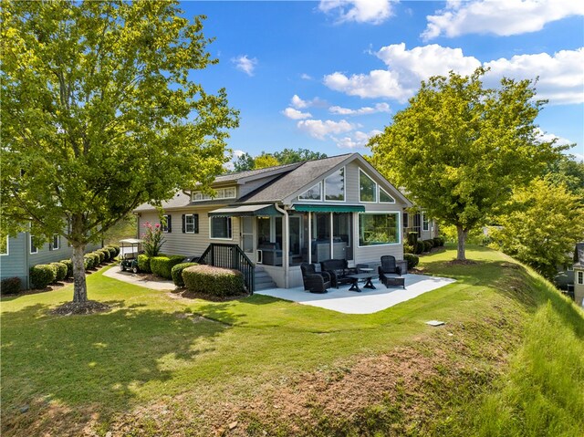 rear view of property with a sunroom, a yard, and a patio